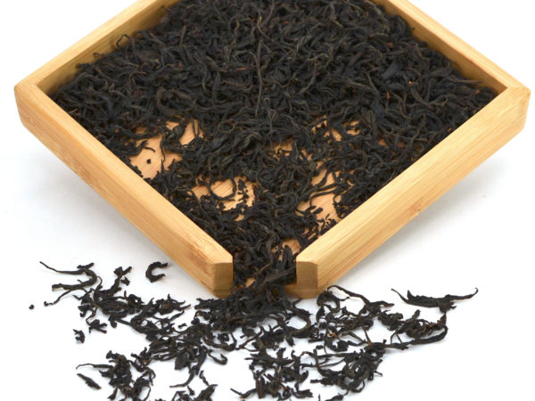 Zui Chun Fang (Drunken Peach) black tea dry leaves in a wooden display box.