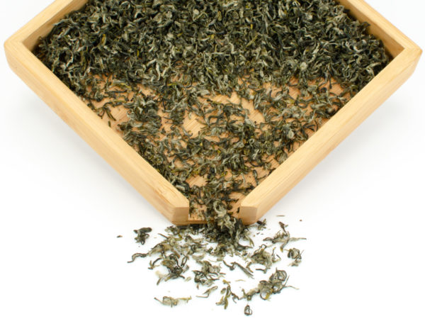 Bi Luo Chun green tea dry leaves in a wooden display box.