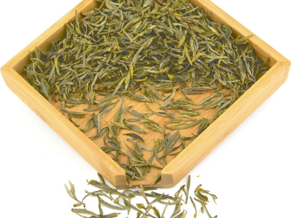 Imperial Huangshan Maofeng green tea dry leaves in a wooden display box.