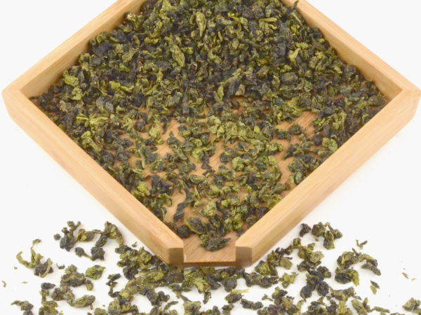 Maliu Mie (Monkey Picked) Anxi wulong tea dry leaves in a wooden display box.