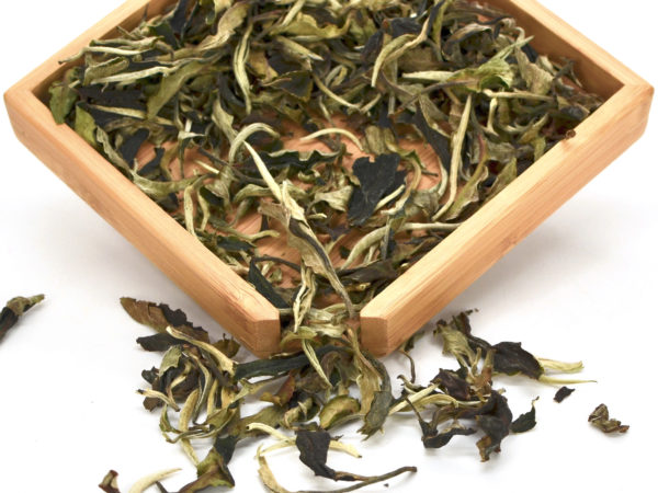 Yue Guang Bai (White Moonlight) puer tea dry leaves in a wooden display box.