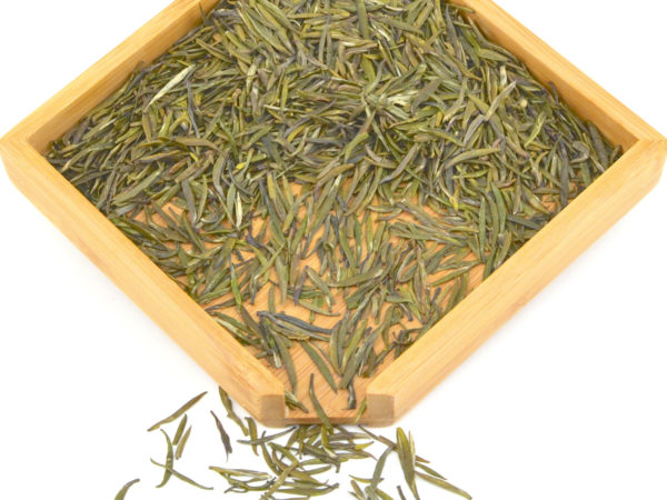 Mengding Huangya yellow tea dry leaves in a wooden display box.