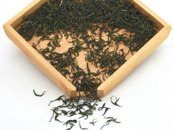 Early Pluck Maojian green tea dry leaves in a wooden display box.