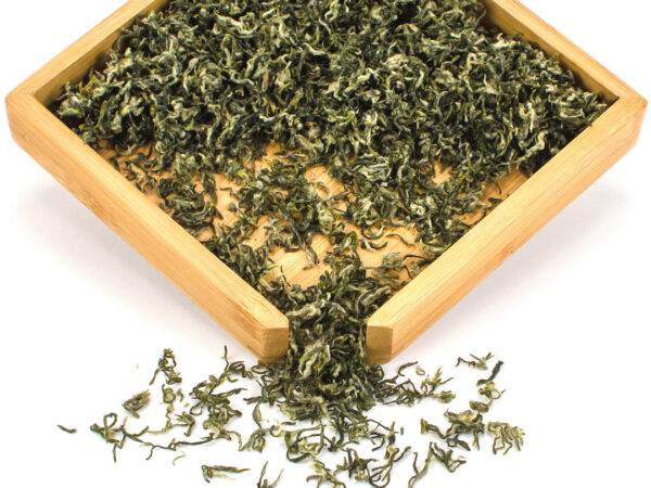 First Pluck Bi Luo Chun green tea dry leaves in a wooden display box.