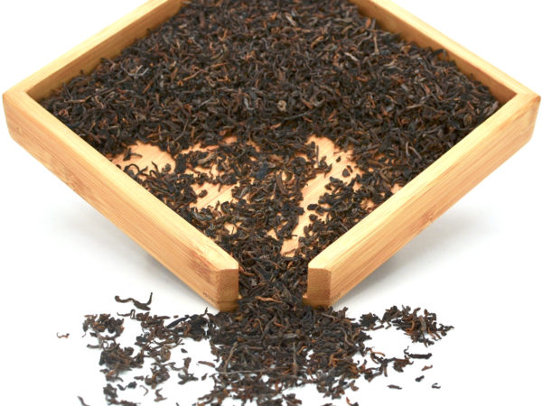 Zijuan Gongting (Purple Leaf Palace Puer) tea dry leaves in a wooden display box.