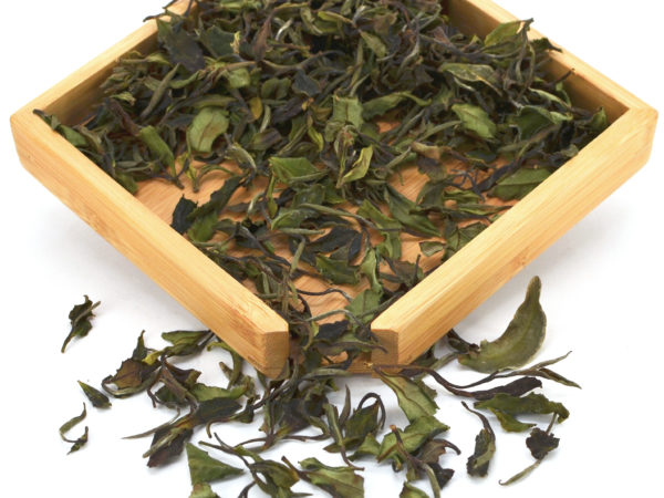 Tieguanyin Baicha (White Tieguanyin) white tea dry leaves in a wooden display box.